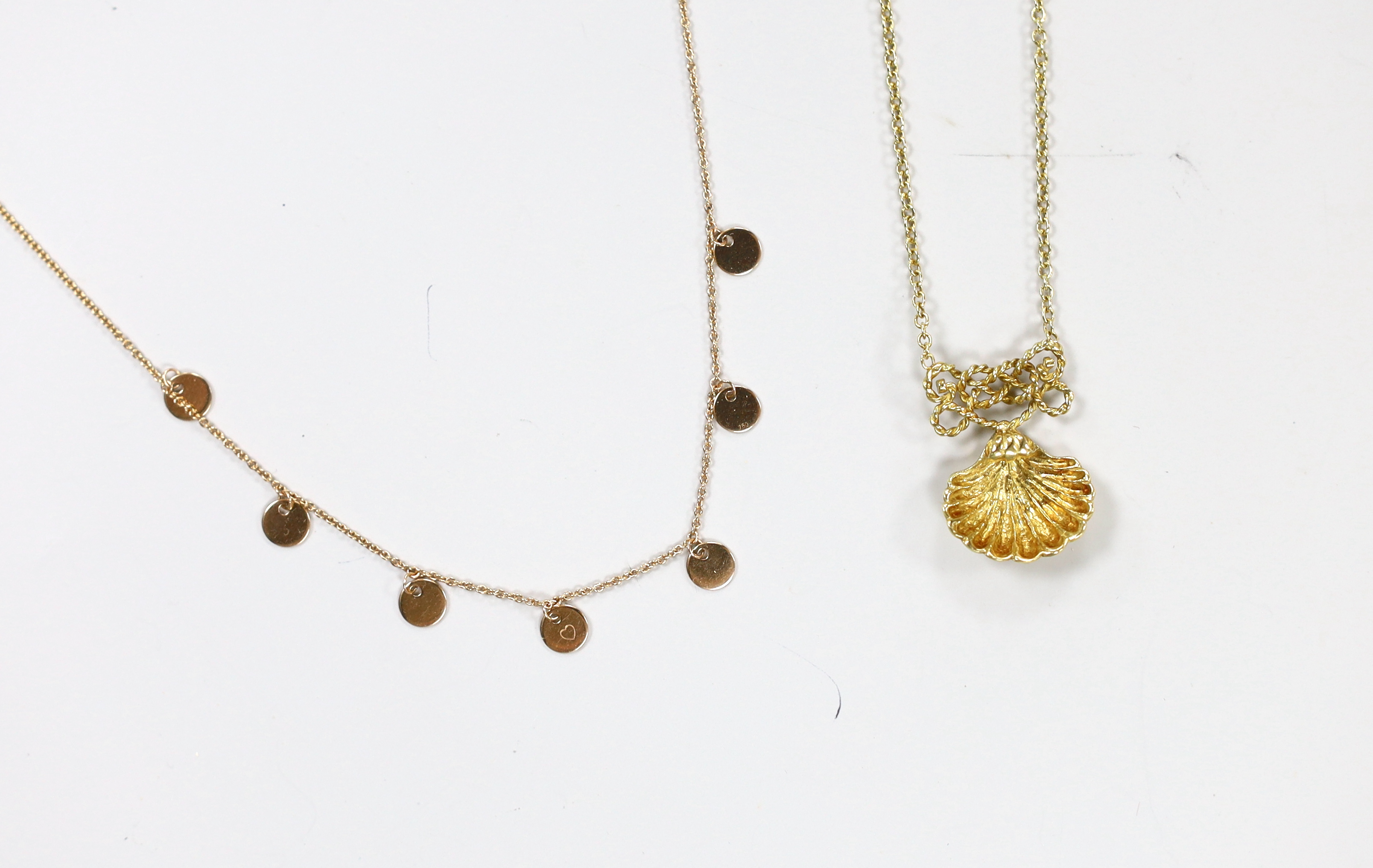 A modern Anna 750 yellow metal necklace, hung with seven small discs, 38cm and a modern Italian 18ct gold shell pendant necklace, 44cm, gross 7.9 grams.